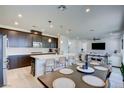 Modern kitchen with dark cabinetry, large island, and dining area at 859 Benning St, Henderson, NV 89011