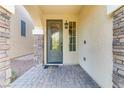 Inviting front entryway with a green door and stone accents at 9635 Stoney Mesa Ct, Las Vegas, NV 89139