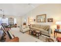 Bright living room featuring a comfortable sofa and a grand piano at 9921 Woodhouse Dr, Las Vegas, NV 89134