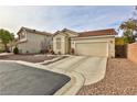 Single-story house with a two-car garage and desert landscaping at , Las Vegas, NV 89148