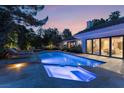 Inviting pool and spa area with outdoor lighting at 10 Wild Dunes Ct, Las Vegas, NV 89113