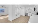 Modern white kitchen with stainless steel appliances at 2028 Hassell Ave, North Las Vegas, NV 89032