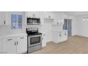 Modern white kitchen with stainless steel appliances at 2028 Hassell Ave, North Las Vegas, NV 89032