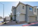 Gray two-story house with attached garage, landscaping, and street view at 2905 Bahama Yellow Ave, North Las Vegas, NV 89086