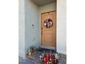 Modern front door with a wreath and potted plants at 2905 Bahama Yellow Ave, North Las Vegas, NV 89086