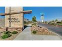 Community entrance sign for Crystal Canyon, with landscaping and street view at 395 Nine Mile Creek Dr, Las Vegas, NV 89138