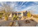 House with drought-tolerant landscaping and a blue awning at 462 Golden State St, Henderson, NV 89012