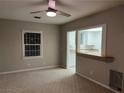 Bright living room with neutral walls and carpet, open to kitchen at 509 5Th St, Boulder City, NV 89005