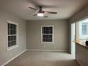 Bright living room featuring a modern ceiling fan, neutral walls and carpet, with great natural light at 509 5Th St, Boulder City, NV 89005