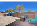 Brick paved backyard with seating area and fire pit at 5648 Ancient Agora St, North Las Vegas, NV 89031