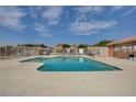 Community pool with surrounding patio and fence at 5648 Ancient Agora St, North Las Vegas, NV 89031