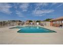 Community swimming pool with surrounding patio furniture at 5648 Ancient Agora St, North Las Vegas, NV 89031