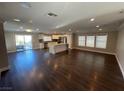 Open concept living area with hardwood floors and kitchen island at 110 La Padania Ave, Las Vegas, NV 89183