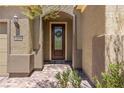 Elegant front door with a stained wood frame and glass insert at 1359 Skylight Way, Mesquite, NV 89034