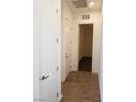 Clean hallway with white doors and tile flooring at 1706 Pondering Ave, North Las Vegas, NV 89031