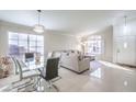 Bright living room featuring a sectional sofa and dining area at 1806 Hollyberry Ct, Las Vegas, NV 89142