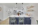 Modern kitchen with white cabinets, quartz countertops, and island seating at 2097 Audrey Hepburn St, Las Vegas, NV 89142