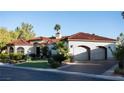 Two-car garage and attractive landscaping enhance this home's curb appeal at 2204 Glenbrook Way, Las Vegas, NV 89117