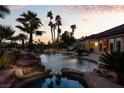 Inviting pool and spa surrounded by lush landscaping and a waterfall feature at 2204 Glenbrook Way, Las Vegas, NV 89117