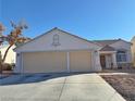 Single story house with a three car garage and landscaped yard at 3760 Yorba Linda Dr, Las Vegas, NV 89122