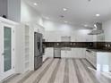 Modern kitchen with stainless steel appliances and white cabinetry at 3760 Yorba Linda Dr, Las Vegas, NV 89122