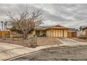 Inviting single-story home with a gravel yard and an attached two-car garage at 4214 Bay Cir, Las Vegas, NV 89122