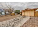 Single-story home with a gravel yard, mature trees, and a private driveway at 4214 Bay Cir, Las Vegas, NV 89122