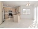 Eat-in kitchen features stainless appliances, ample counter space, and lots of natural light at 4929 Morning Falls Ave, Las Vegas, NV 89131
