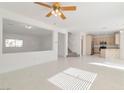 Bright, open-concept living space with recessed lighting, tile floors and neutral color palette at 4929 Morning Falls Ave, Las Vegas, NV 89131