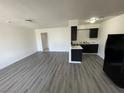 Open living room and kitchen with laminate floors at 520 S 13Th St # D26, Las Vegas, NV 89101