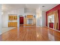 Living room featuring hardwood floors, built-in cabinetry, and red accent wall at 521 Intrepid St, Pahrump, NV 89048