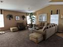 Spacious living room with sectional sofa and large windows at 5655 White Dune St, Las Vegas, NV 89113