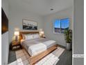 Spacious bedroom with large window and wood flooring at 5960 Palmilla St # 3, North Las Vegas, NV 89031