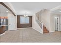 Spacious dining area with tile floors and a staircase at 6650 Apollos Gate Ct, Las Vegas, NV 89142