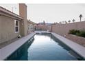 Inviting rectangular pool with a concrete deck and a partial view of the backyard at 8032 Deep Stone Ave, Las Vegas, NV 89149