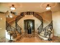 Elegant double staircase with ornate iron railings at 9101 Alta Dr # 1802, Las Vegas, NV 89145