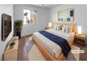 Bright bedroom with large bed, TV, and modern decor at 9511 Withering Pine St, Las Vegas, NV 89123