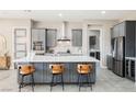 Modern kitchen with gray cabinetry, quartz countertops, and stainless steel appliances at 107 Reflection Cove Dr, Henderson, NV 89011