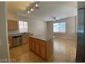 Open kitchen with island and hardwood floors at 1434 Summer Glow Ave, Henderson, NV 89012