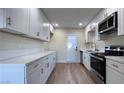 Modern kitchen featuring white shaker cabinets and quartz countertops at 210 Nebraska Ave, Henderson, NV 89015