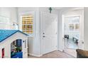 Bright entryway with white door, gray walls, and a view into a sitting area at 2225 Chandler Ranch Pl, Laughlin, NV 89029