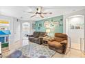 Relaxing living room with two brown recliners, a teal accent wall, and a ceiling fan at 2225 Chandler Ranch Pl, Laughlin, NV 89029