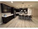 Modern kitchen with dark cabinetry, island, and stainless steel appliances at 2828 Shadows Edge Ct, Henderson, NV 89052