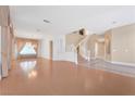 Open living space with hardwood floors and a staircase at 31 Castle Creek Ct, Las Vegas, NV 89148