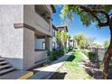 Exterior showing well-maintained landscaping along a walkway, enhancing the property's curb appeal at 45 Maleena Mesa St # 223, Henderson, NV 89074