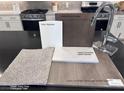 Kitchen features quartz countertops and luxury vinyl plank flooring at 4748 Parkarbor Ave, Las Vegas, NV 89141