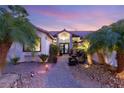 Elegant entryway to a beautiful home featuring a water fountain and mature landscaping at 4920 Rancho Bernardo Way, Las Vegas, NV 89130