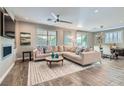 Spacious living room with large sectional sofa, fireplace, and wood-look tile floors at 5627 Felicity Cir, Las Vegas, NV 89139