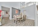 Spacious dining room with wood floors and a modern table at 6554 Macdoogle St, Las Vegas, NV 89166