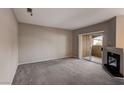 Living room with fireplace, sliding glass door, and carpet at 9000 Las Vegas Blvd # 2134, Las Vegas, NV 89123
